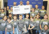 
			
				                                NC Representative Jared Lowery, Lumbee Tribal Chairman John L. Lowery, Eric Collins, Spectrum Director of State Government Affairs and the children from the Lumbee Tribe Boys & Girls Club program participate in a photo with their “Bring a Veteran to School Day” shirts and a check presented from Spectrum to the club.
                                 Contributed photo | LTNC

			
		